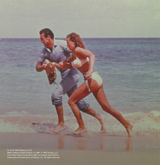 photo © Danjaq LLC, MGM, United Artists Sean Connery as James Bond and Ursula Andress as Honey Ryder running on the Jamaican beach in Dr. No
