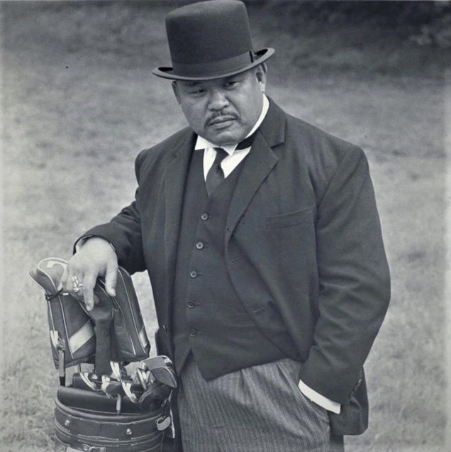 Harold Sakata as Oddjob in Goldfinger, wearing a Lock & Co. Hat